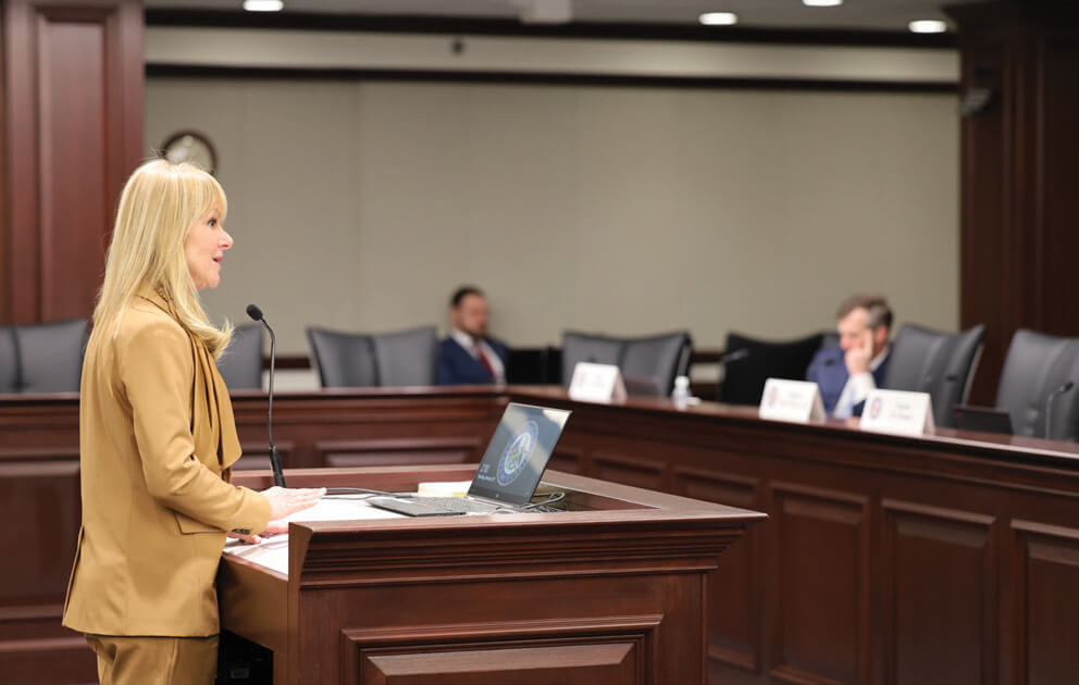 Individual addressing an audience at a podium
