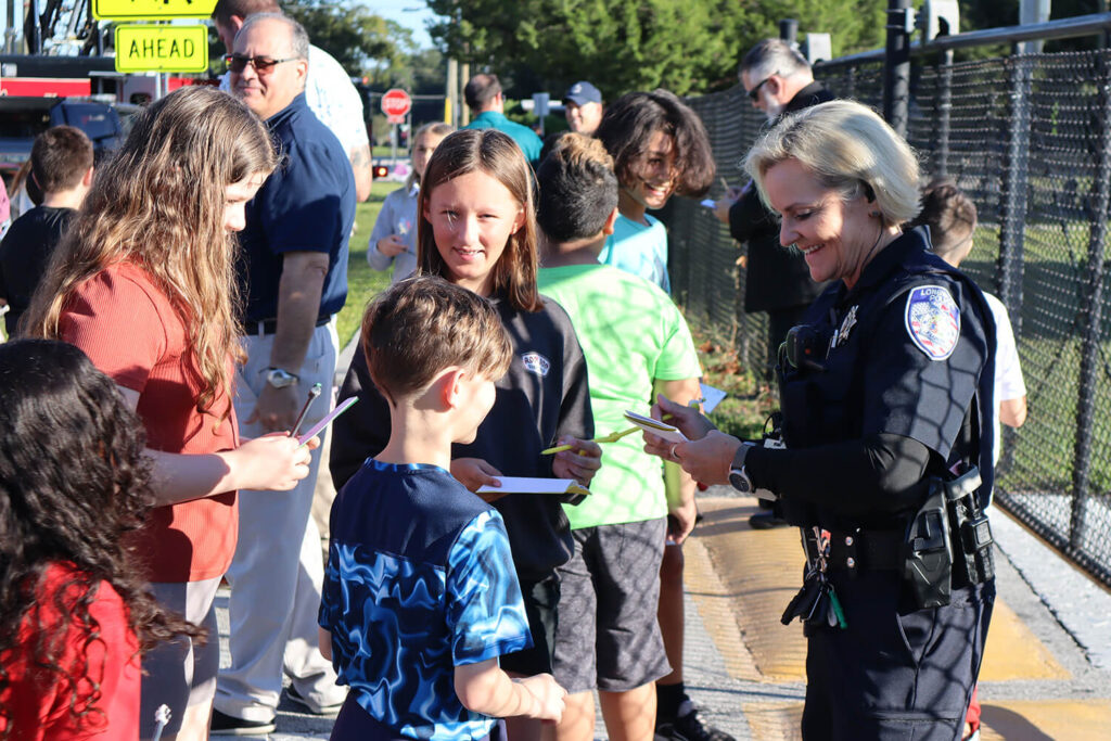 A police officer talking to several children
