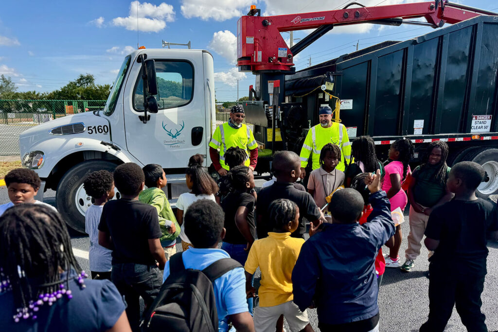 Florida city workers talking to a group of children