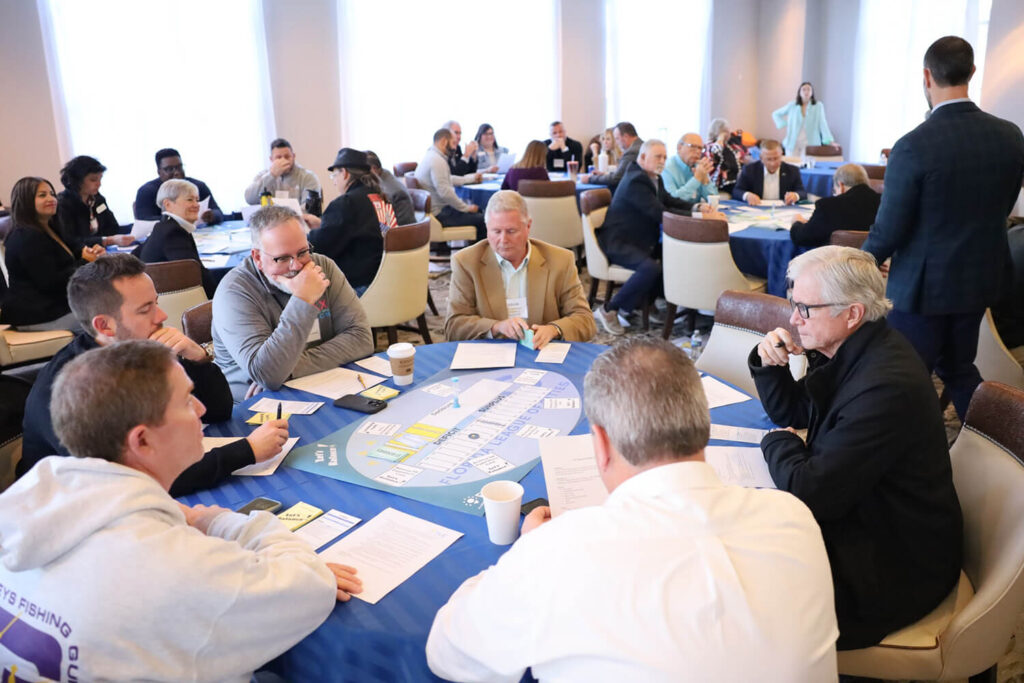A group of individuals at a table attending the Institutute for Elected Municipal Officials