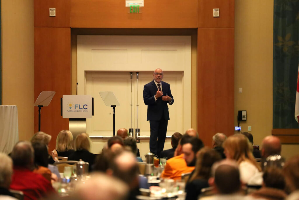 Man addressing a crowd of people in a conference hall