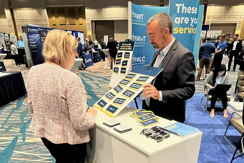Two individuals at a tradeshow loan booth